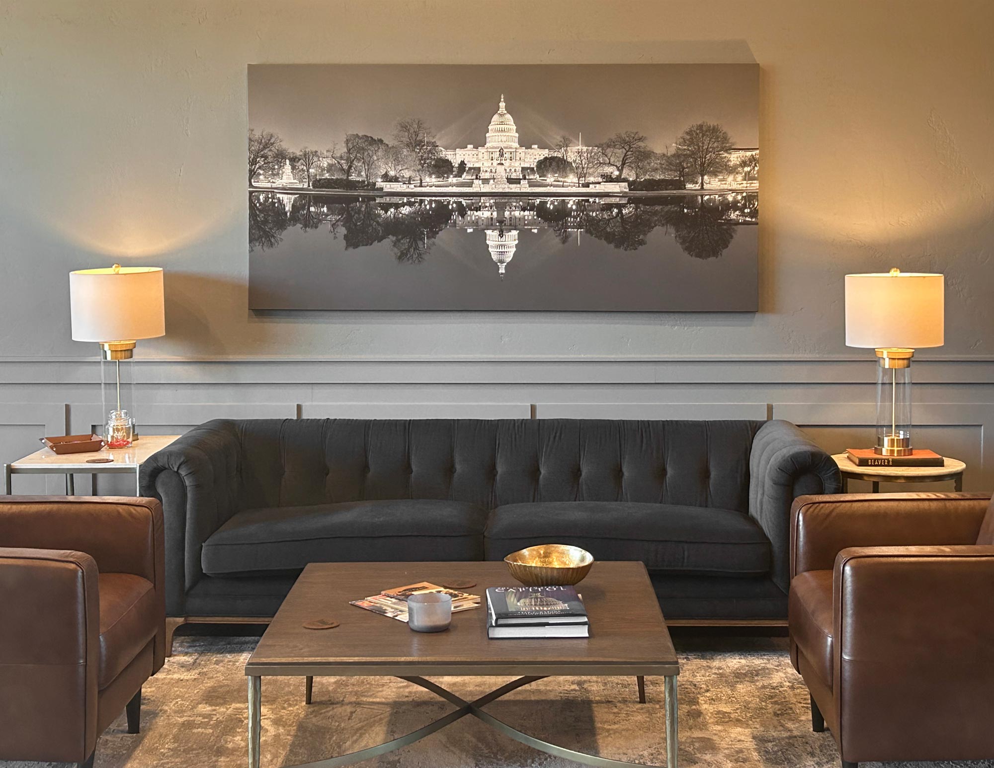 A VAST canvas print of "U.S. Capitol Building & Reflecting Pool in Early Spring Twilight B&W" by Tim Lo Monaco in an office.