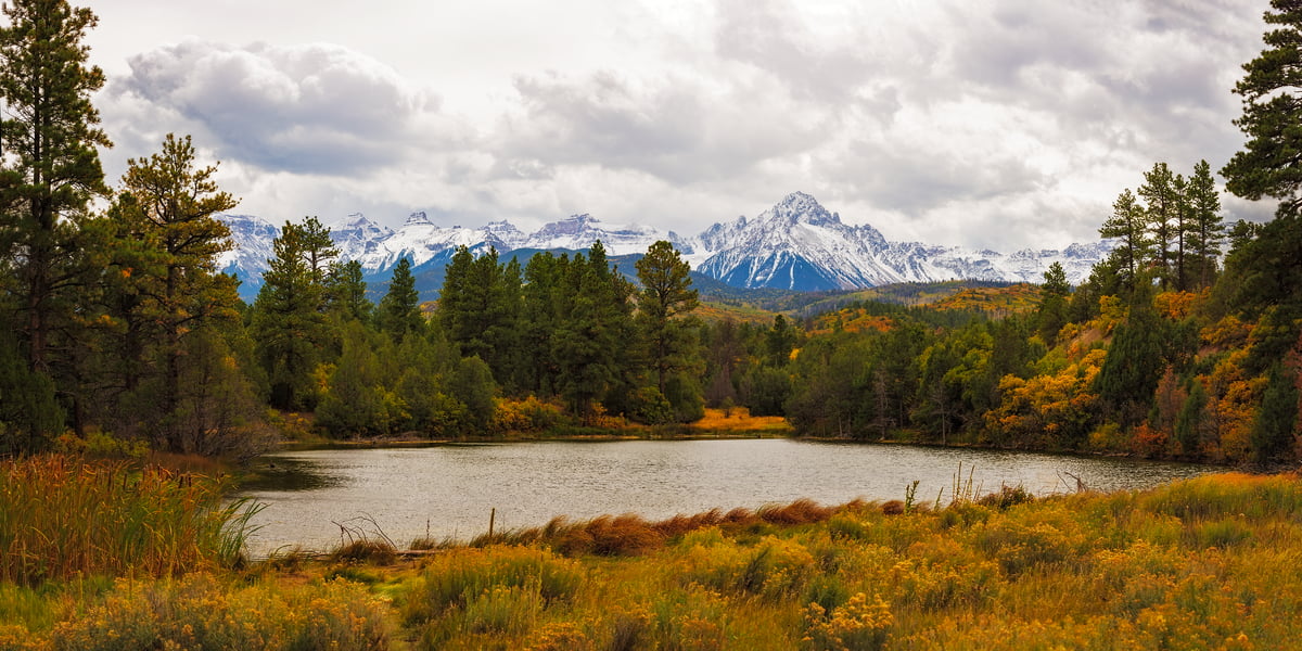 249 megapixels! A very high resolution, large-format VAST photo print of a small lake, forest, hills, and mountain range; landscape photograph created by John Freeman in Ridgeway, Colorado.