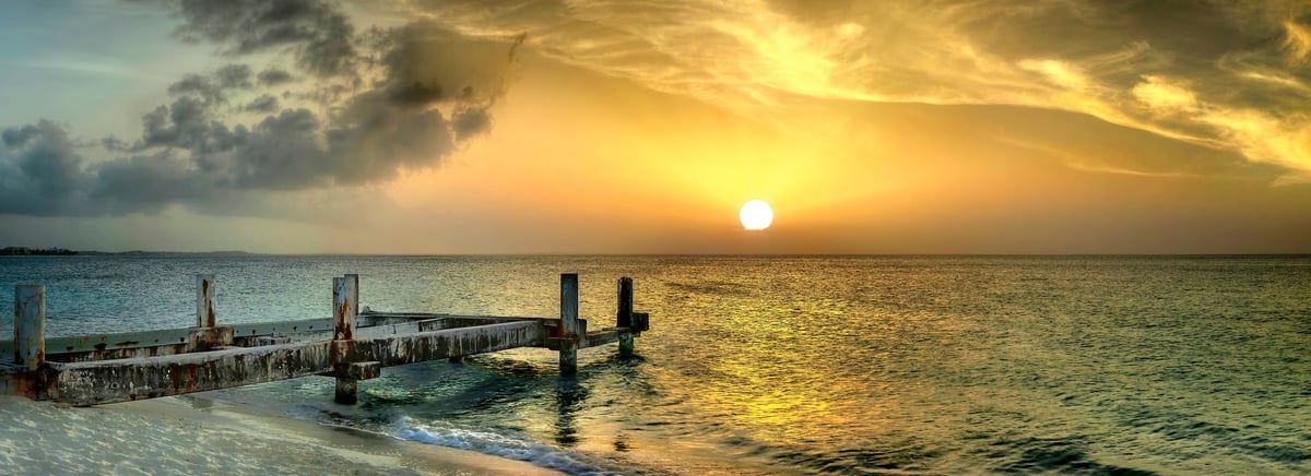 130 megapixels! A fine art photo of an old pier going into the ocean at sunset, representing old age; ocean sunset photograph created by Phil Crawshay in Grace Bay, Turks and Caicos Islands.
