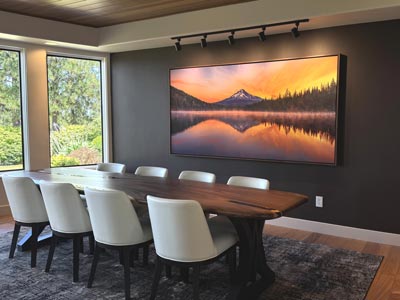 "Calm Mist" by Chris Collacott, an ultra-high-resolution canvas print of a mountain landscape photograph, hanging in the dining room of a home.